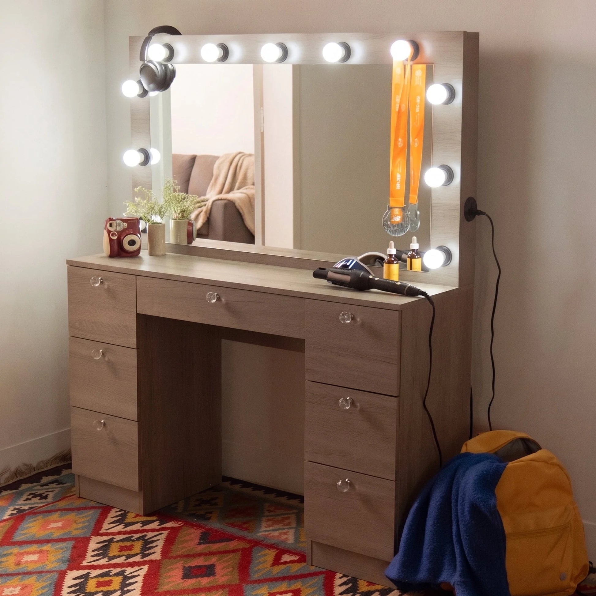 Wooden vanity with mirror and lights in a room setting